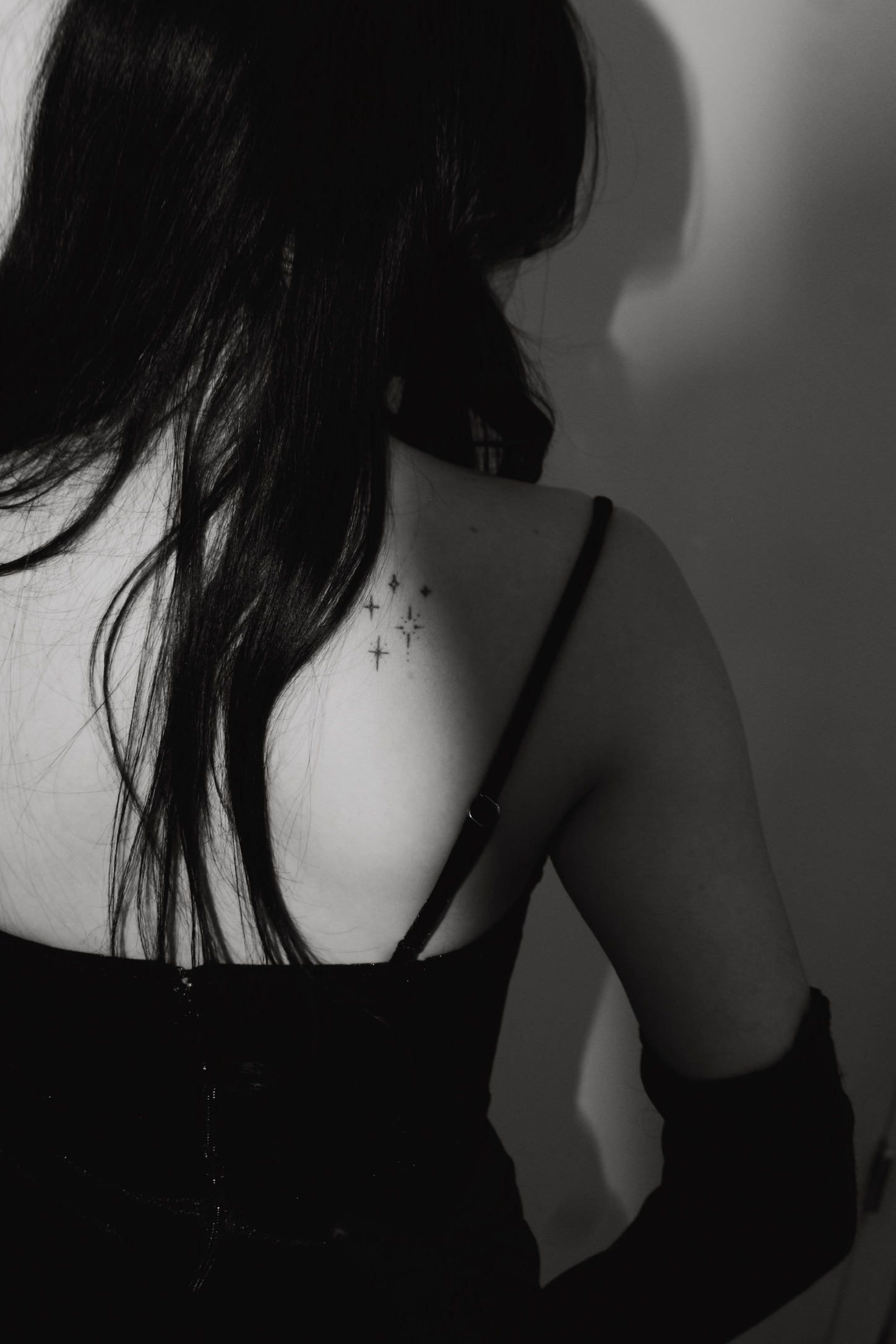 Black and white portrait of Eponine Lorenzi showing her star tattoo